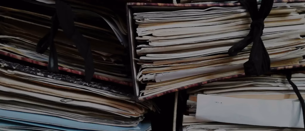 Stacks of old paper files folders