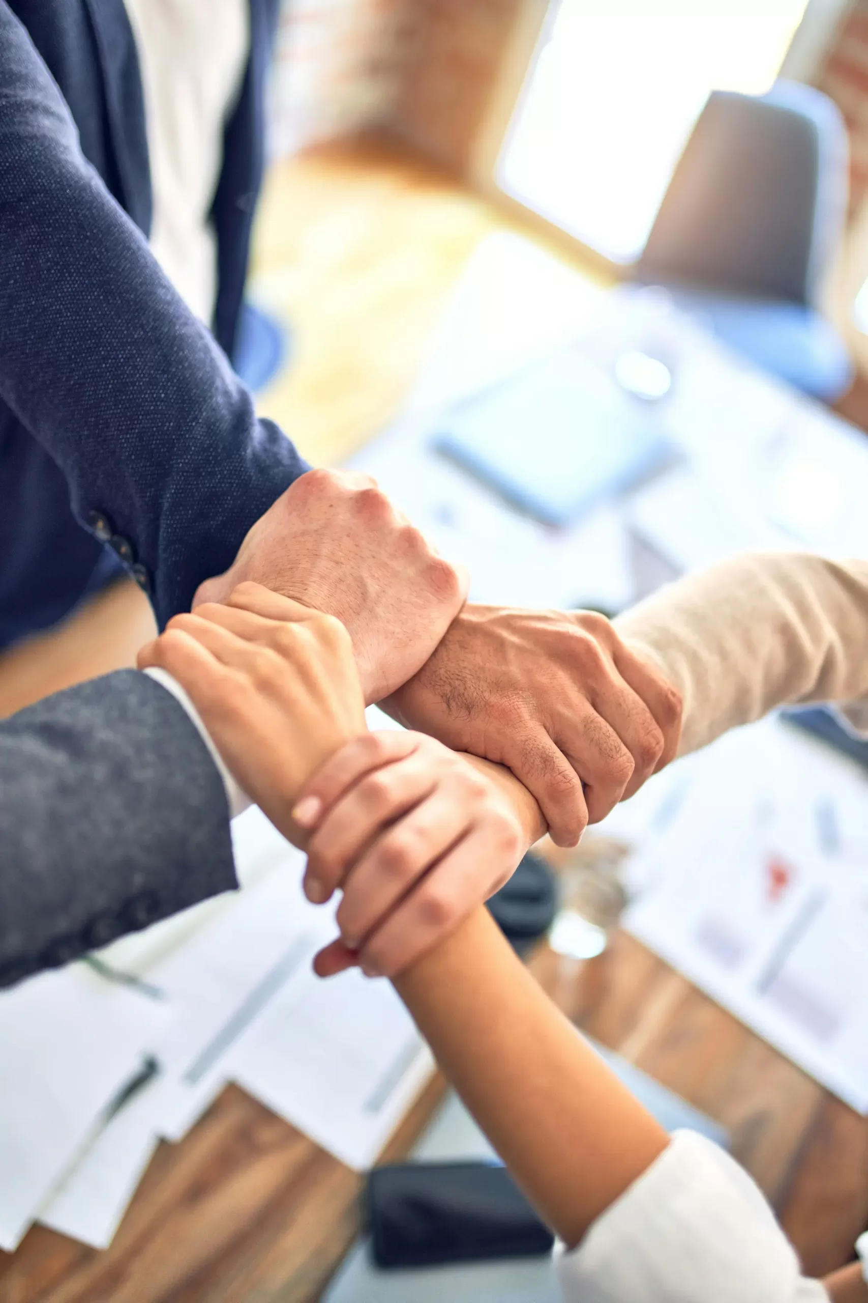 Group of business workers standing with hands together
