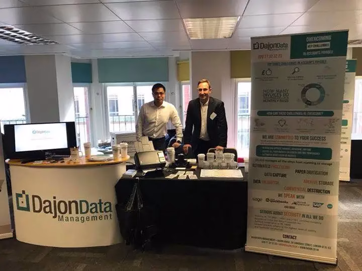 Albert and Damien behind Dajon's stand at the Accounts Payable Association event