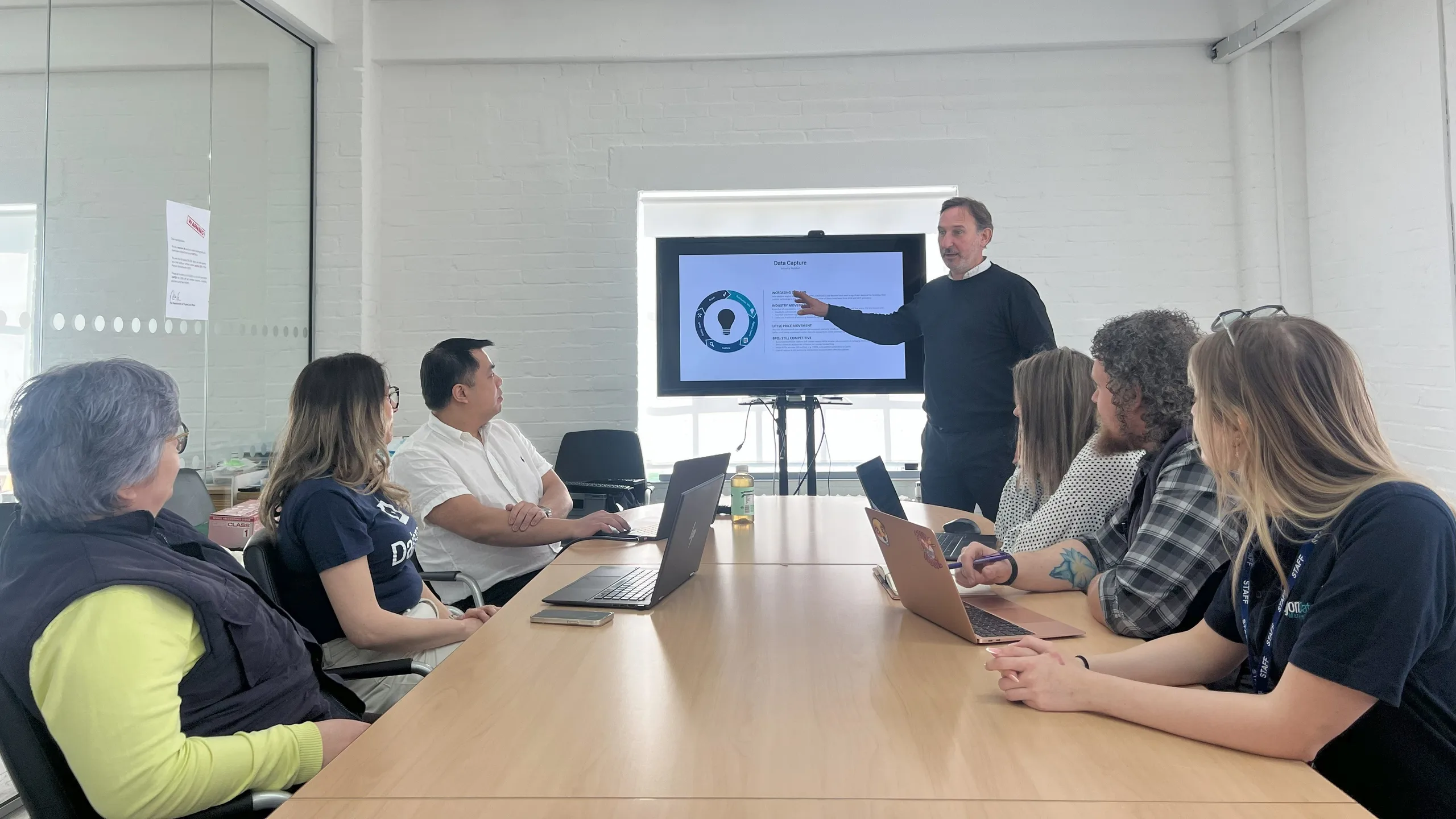 Damien presenting to team in Dajon boardroom