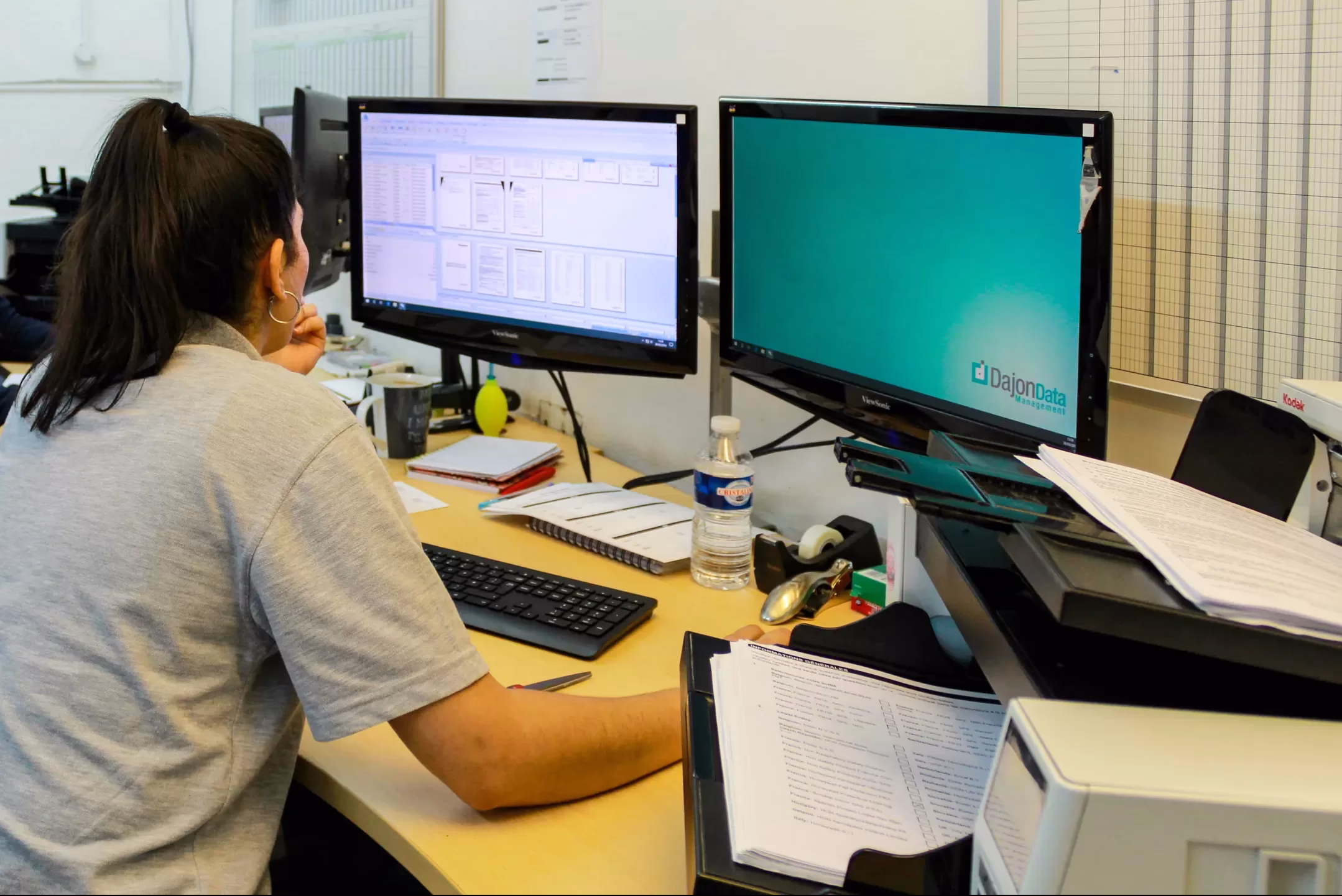 Dajon scanning operator checking digitised images at their workstation